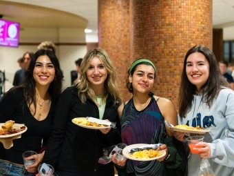 four students at the Night Owl Breakfast at Commons